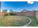 Large backyard with ample green space, a block wall, and clear blue skies at 4605 W Fawn Dr, Laveen, AZ 85339