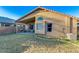 Backyard featuring a covered patio, lush green lawn, and a well-maintained exterior at 4605 W Fawn Dr, Laveen, AZ 85339