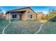 The backyard features a covered patio, green lawn, and space for outdoor entertaining and relaxation at 4605 W Fawn Dr, Laveen, AZ 85339