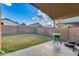Covered patio with BBQ overlooking a spacious backyard, creating an inviting outdoor space at 4605 W Fawn Dr, Laveen, AZ 85339