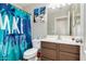 Tropical-themed bathroom with a stylish vanity, and vibrant, eye-catching shower curtain at 4605 W Fawn Dr, Laveen, AZ 85339