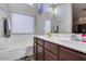 Bright bathroom featuring a double sink vanity and soaking tub below the window at 4605 W Fawn Dr, Laveen, AZ 85339
