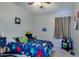 Bright bedroom featuring a dinosaur-themed bed set and neutral gray walls at 4605 W Fawn Dr, Laveen, AZ 85339
