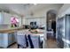 Bright kitchen featuring white cabinetry, modern appliances, and eat-in island at 4605 W Fawn Dr, Laveen, AZ 85339