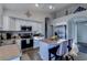 Bright kitchen features an island with seating, stainless steel appliances and white cabinetry at 4605 W Fawn Dr, Laveen, AZ 85339