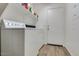 Laundry room features a washer, dryer, overhead shelves, and access to the exterior at 4605 W Fawn Dr, Laveen, AZ 85339