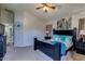 Spacious main bedroom features a ceiling fan, soft carpet, and an ensuite bathroom at 4605 W Fawn Dr, Laveen, AZ 85339