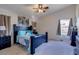 Cozy main bedroom features a ceiling fan, soft carpet, and an ensuite bathroom at 4605 W Fawn Dr, Laveen, AZ 85339