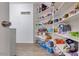 Walk-in pantry features bright lighting, white shelving and ample storage space at 4605 W Fawn Dr, Laveen, AZ 85339