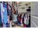 Walk-in closet includes built-in shelving and ample space for clothing and accessories at 4605 W Fawn Dr, Laveen, AZ 85339