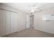 A carpeted bedroom featuring a ceiling fan and closet doors at 5135 E Evergreen St # 1159, Mesa, AZ 85205