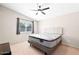 A carpeted main bedroom with a window, ceiling fan and a bed at 5135 E Evergreen St # 1159, Mesa, AZ 85205