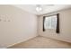 A carpeted bedroom with a window and a ceiling fan at 5135 E Evergreen St # 1159, Mesa, AZ 85205