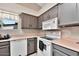 A bright kitchen features stainless steel appliances, light countertops and stylish gray cabinets at 5135 E Evergreen St # 1159, Mesa, AZ 85205