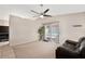 Cozy living room with neutral walls, carpet, and large window overlooking the backyard at 5135 E Evergreen St # 1159, Mesa, AZ 85205
