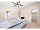A carpeted main bedroom featuring a ceiling fan, and closet doors at 5135 E Evergreen St # 1159, Mesa, AZ 85205