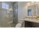 Modern bathroom featuring tile shower with glass door, updated fixtures, toilet, and vanity with granite countertop at 5302 E Van Buren St # 3040, Phoenix, AZ 85008