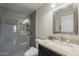 Modern bathroom featuring a glass-enclosed shower, granite countertop, and sleek fixtures at 5302 E Van Buren St # 3040, Phoenix, AZ 85008