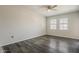 Bright, airy bedroom featuring a ceiling fan, neutral walls, and wood flooring at 5302 E Van Buren St # 3040, Phoenix, AZ 85008