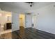 Bright bedroom featuring hard wood floors, a ceiling fan, and views into the ensuite bathroom and walk-in closet at 5302 E Van Buren St # 3040, Phoenix, AZ 85008
