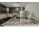 Galley kitchen featuring granite countertops, a tiled backsplash, and stainless steel appliances at 5302 E Van Buren St # 3040, Phoenix, AZ 85008