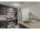 Bright kitchen features granite countertops, dark cabinets and stainless steel appliances at 5302 E Van Buren St # 3040, Phoenix, AZ 85008