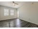 Bright living room with dark wood floors, ceiling fan and neutral paint at 5302 E Van Buren St # 3040, Phoenix, AZ 85008