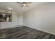 Well-lit living room featuring an open floor plan, ceiling fan, and wood floors at 5302 E Van Buren St # 3040, Phoenix, AZ 85008