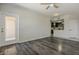 Open floorplan living room features wood flooring, ceiling fan, and access to the kitchen at 5302 E Van Buren St # 3040, Phoenix, AZ 85008