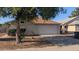 Well-maintained home showcasing a two-car garage, complemented by a mature tree, driveway, and cozy curb appeal at 537 E Piute Ave, Phoenix, AZ 85024