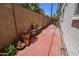 Enclosed brick-paved backyard featuring mature foliage, potted plants, and a privacy wall at 5550 N 12Th St # 15, Phoenix, AZ 85014