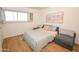Cozy bedroom featuring a comfortable bed, natural light, and warm wood floors at 5550 N 12Th St # 15, Phoenix, AZ 85014