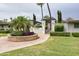 Inviting community entrance with lush greenery, palm trees, and manicured landscaping at 5550 N 12Th St # 15, Phoenix, AZ 85014