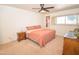 Cozy main bedroom with comfortable furniture, a ceiling fan, and natural lighting at 5550 N 12Th St # 15, Phoenix, AZ 85014