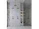 Modern bathroom shower with multiple shower heads, marble accents, and built-in shelving at 5636 E Caballo Dr, Paradise Valley, AZ 85253
