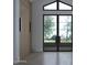 Bright entryway featuring a large window with natural light and contemporary wood door at 5636 E Caballo Dr, Paradise Valley, AZ 85253