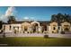 Beautiful single-story home with a well-manicured lawn, desert landscaping, and a grand entrance at 5636 E Caballo Dr, Paradise Valley, AZ 85253