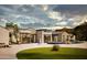 Luxury home showcasing a dark tiled pool with desert landscaping at 5636 E Caballo Dr, Paradise Valley, AZ 85253
