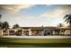 Expansive home with a luxurious pool, ample lounge seating, and palm trees at 5636 E Caballo Dr, Paradise Valley, AZ 85253