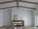 Bright living room with a modern fireplace, wood beam ceiling, and open space at 5636 E Caballo Dr, Paradise Valley, AZ 85253