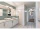 Modern double sink bathroom featuring a tiled accent wall and tile flooring at 6803 E Main St # 4415, Scottsdale, AZ 85251