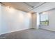 Bright bedroom featuring a window view and neutral gray carpet, complemented by modern track lighting at 6803 E Main St # 4415, Scottsdale, AZ 85251
