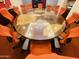 Conference room with a large round wooden table and red office chairs, designed for professional meetings at 6803 E Main St # 4415, Scottsdale, AZ 85251