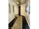 Hallway with decorative mosaic flooring and modern wall sconces leading to a door at 6803 E Main St # 4415, Scottsdale, AZ 85251