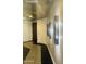 Hallway with decorative mosaic flooring and modern wall sconces leading to doorways at 6803 E Main St # 4415, Scottsdale, AZ 85251