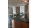 Kitchen island with a unique glass countertop, bar stools and modern design elements at 6803 E Main St # 4415, Scottsdale, AZ 85251