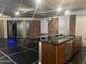 Modern kitchen featuring a glass countertop and stainless steel appliances, accentuated by brick walls at 6803 E Main St # 4415, Scottsdale, AZ 85251