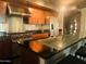 Modern kitchen featuring stainless steel appliances, wooden cabinetry, and black countertops at 6803 E Main St # 4415, Scottsdale, AZ 85251