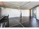 Spacious living room with black tile floors, track lighting, and a sliding glass door at 6803 E Main St # 4415, Scottsdale, AZ 85251