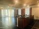 Open living space with kitchen, brick accent wall, large windows, and access to a balcony at 6803 E Main St # 4415, Scottsdale, AZ 85251